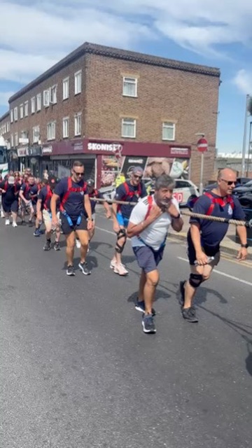 Rags Sandhu pulls alongside fellow volunteers